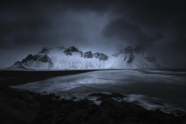 A dark atmosphere above Vestrahorn, depicted from Stokksnes in eastern iceland, near Hofn. The image was taken during a heavy storm with winds blowing up to 100 mph.