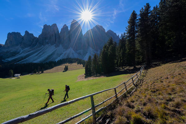 Odle,Funes, Dolomites,Trentino alto Adige, Italy
Two hikers photographed as they pass through the valley below the Odle. In the foreground a fence