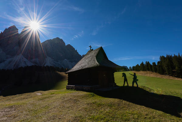 Odle,Funes, Dolomites,Trentino alto Adige, Italy
A church under the Odle photograph backlight. In silhouette 2 hikers observe the mountains
