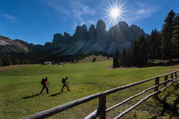 Odle,Funes, Dolomites,Trentino alto Adige, Italy
Two hikers photographed as they pass through the valley below the Odle. In the foreground a fence
