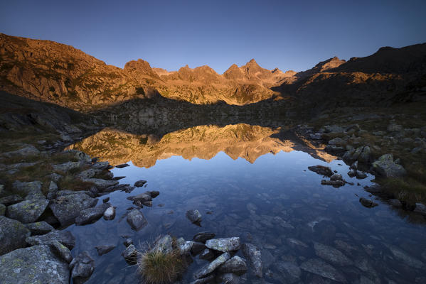 Val Nambrone,Adamello Brenta Park, Trentino Alto Adige, Italy. 

The Presanella range peaks reflected into the Black Lake at the sunrise