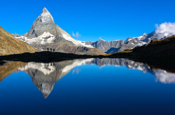 Riffelsee Lake, Matterhorn, Switzerland

Three hikers in silhouette reflected in the lake Riffelsee, under the Matterhorn