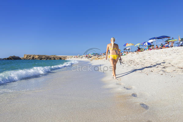 Young Girl Wit Yellow Swimsuit Walks On The Beach Of Is Arutas Cabras Oristano Province Sardinia Italy Europe