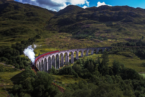 Train on famous Glenfinnan viaduct, Scotland, United Kingdom